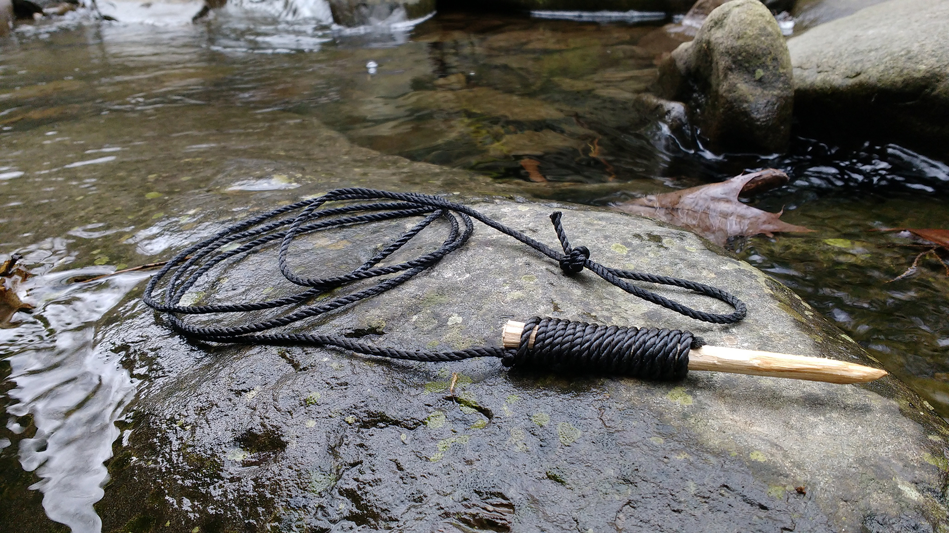 Top Strike Fishing DIY Fish Stringer Photographed on a Creek Rock