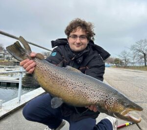 Huge brown trout being held by angler Eli Poloski on Instagram.